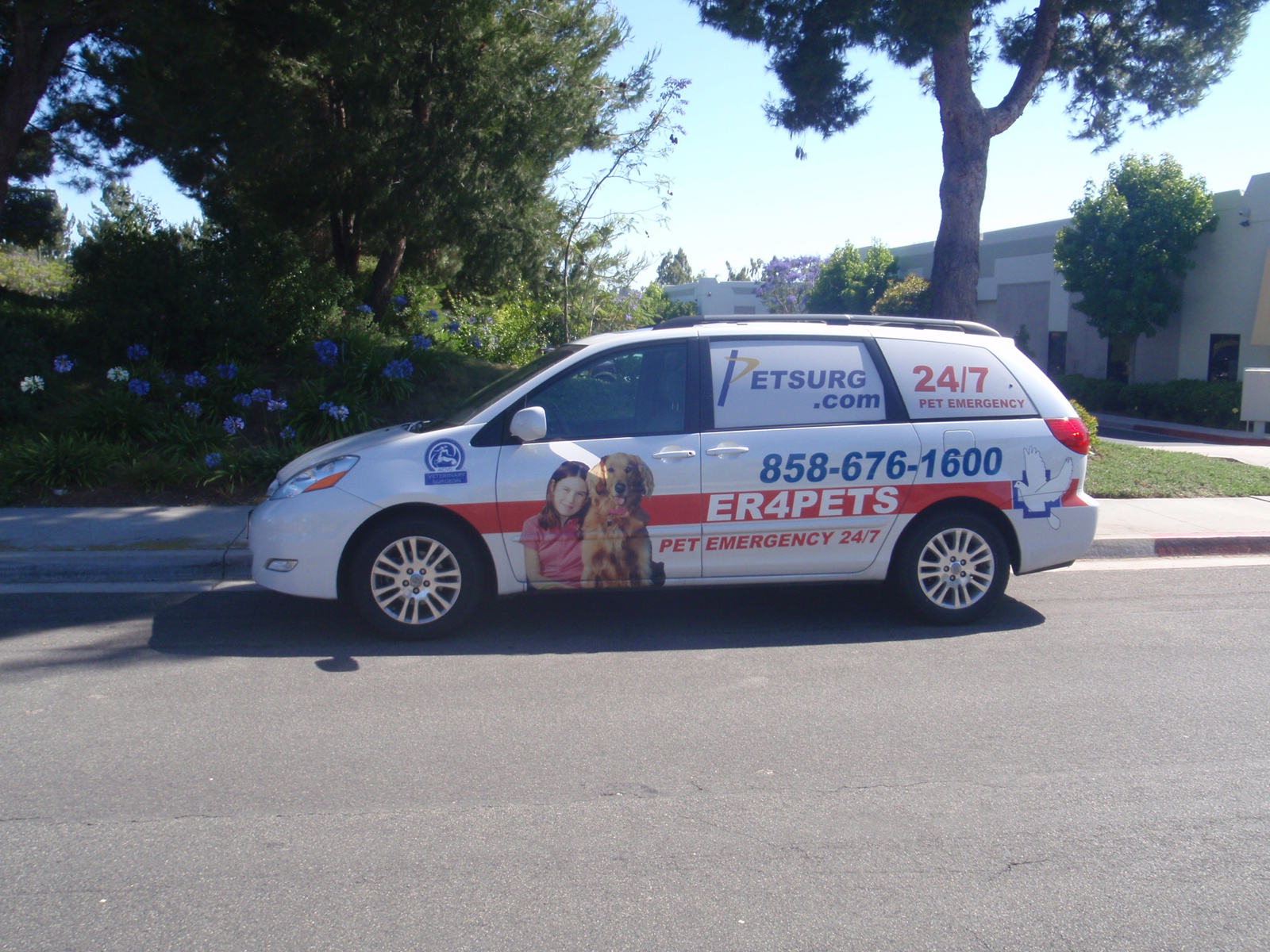 ER4PETS branded vehicle for 24/7 pet emergency veterinary services in San Diego, CA ER4PETS branded vehicle wrap on a minivan displaying the practice phone number 858-676-1600 and 24/7 pet emergency messaging, representing PETSURG and ER4PETS serving the San Diego community